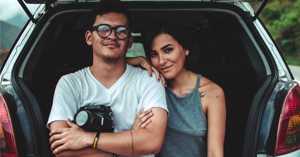 Husband and wife in front of car