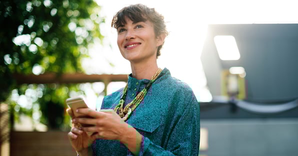Happy woman holding phone