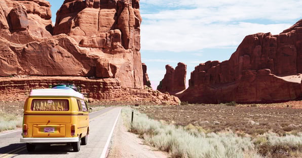 Yellow bus on desert road