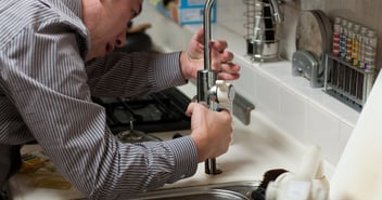 Someone putting in a faucet