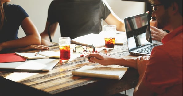 Coworkers sitting together at table