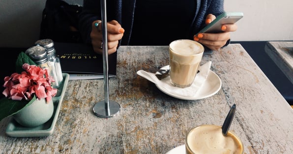 Someone at a cafe enjoying coffee