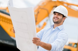 Architect looking at blueprints in a building site