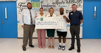 five adults holding a check from Levo Cares Foundation the Boys & Girls Clubs of the Sioux Empire