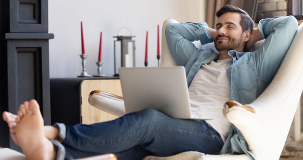 Guy relaxed at the computer because he has direct deposit