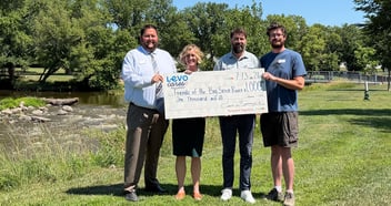 Four people holding a check from Levo Cares Foundation to the Friends of the Big Sioux River