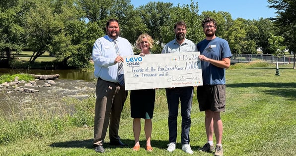 Four people holding a check from Levo Cares Foundation to the Friends of the Big Sioux River