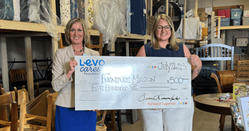 Jen presents $500.00 to the Furniture Mission