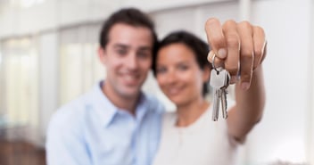Man and woman holding house keys