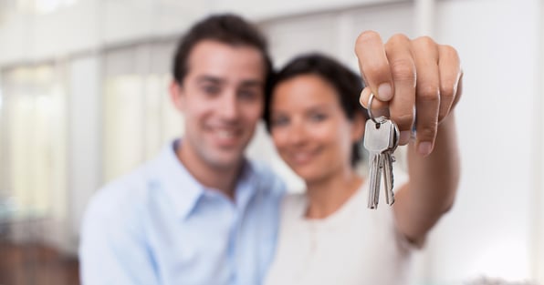 Man and woman holding house keys