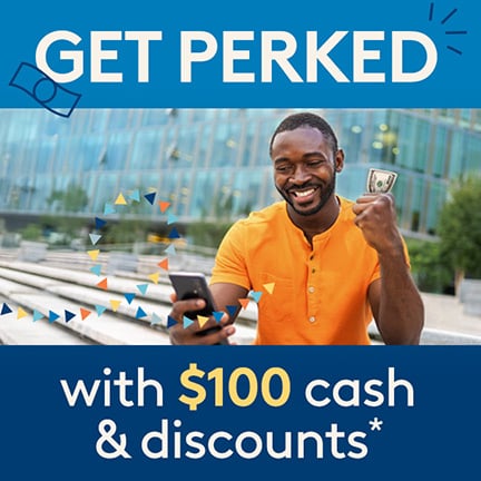 A man smiling at his phone with a $100 bill in hand. Text on image A man smiling at his phone with a $100 bill in hand. Text on image