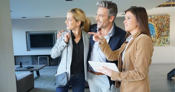Husband and wife speaking with real estate agent