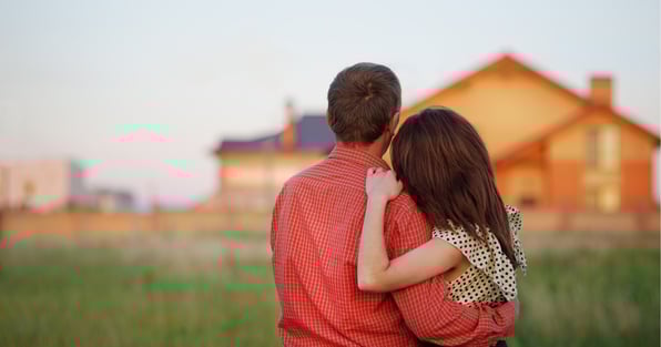 Man and woman in front of home