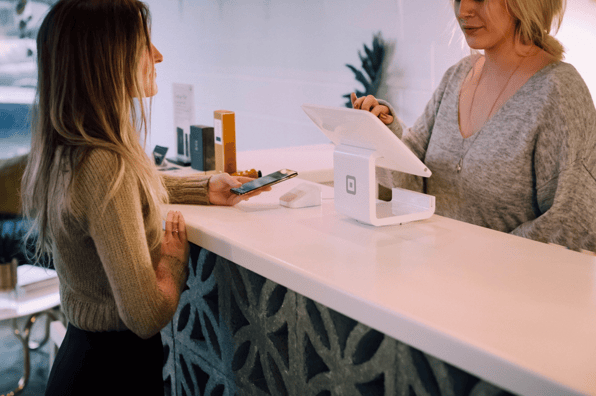 Woman at counter with phone