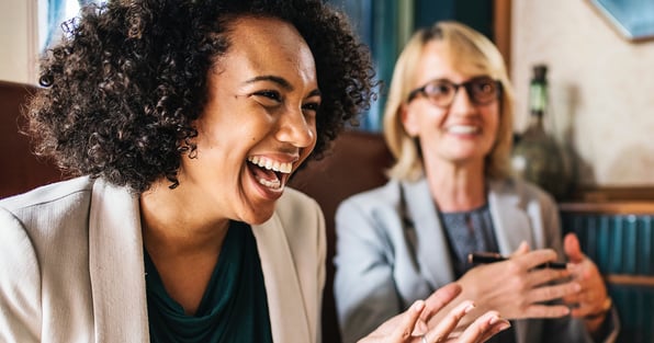 Two women smiling and laughing