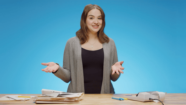 Woman in front of a pile of papers