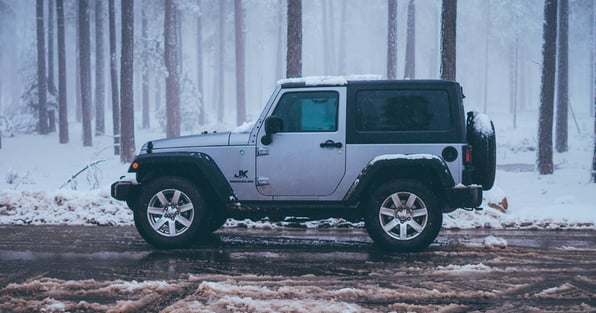 A grey Jeep in the snow