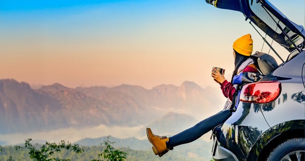 Vehicle with Woman Viewing Wintery Scenic Mountains