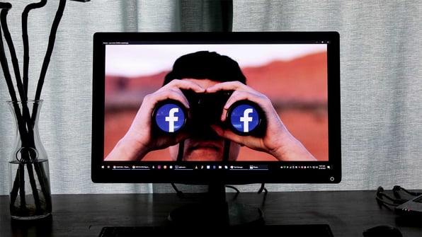 Man with binoculars on computer screen