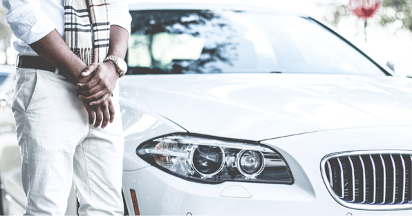 Man standing in front of white car