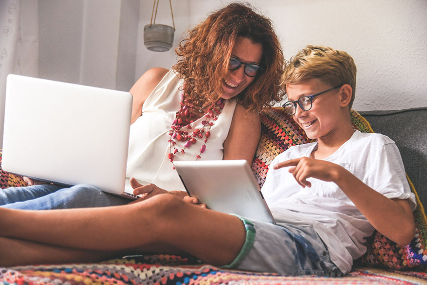 mother-son-couch-on-laptops mother-son-couch-on-laptops